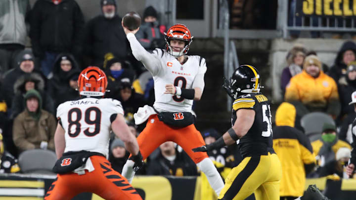 Jan 4, 2025; Pittsburgh, Pennsylvania, USA;  Cincinnati Bengals quarterback Joe Burrow (9) passes to tight end Drew Sample (89) as Pittsburgh Steelers linebacker Alex Highsmith (56) pressures during the second quarter at Acrisure Stadium. Mandatory Credit: Charles LeClaire-Imagn Images