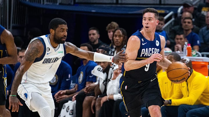 Mar 27, 2023; Indianapolis, Indiana, USA; Indiana Pacers guard T.J. McConnell (9) dribbles the ball while Dallas Mavericks guard Kyrie Irving (2) defends in the second quarter at Gainbridge Fieldhouse. Mandatory Credit: Trevor Ruszkowski-Imagn Images