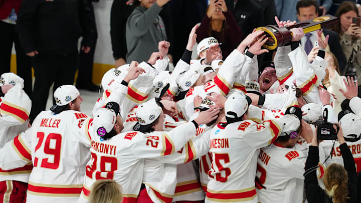 Apr 11, 2026; Las Vegas, Nevada, United States; The Denver Pioneers celebrate with the trophy after defeating the Wisconsin Badgers in the championship game of the NCAA men's ice hockey Frozen Four at T-Mobile Arena.