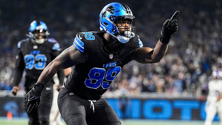 Detroit Lions defensive end Za'Darius Smith (99) celebrates a sack against Minnesota Vikings quarterback Sam Darnold (14) during the first half at Ford Field in Detroit on Sunday, Jan. 5, 2025.