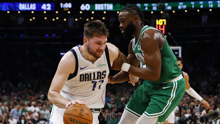 Jun 17, 2024; Boston, Massachusetts, USA; Dallas Mavericks guard Luka Doncic (77) dribbles the ball against Boston Celtics guard Jaylen Brown (7) during the second quarter in game five of the 2024 NBA Finals at TD Garden. Mandatory Credit: Peter Casey-Imagn Images