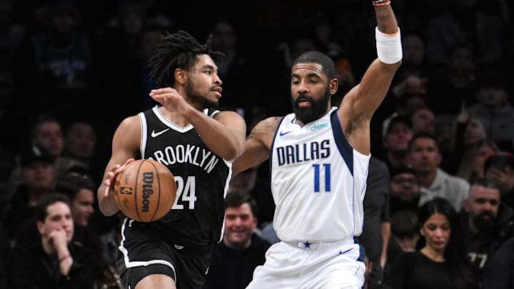 Brooklyn Nets guard Cam Thomas drives to the basket while being defended by Dallas Mavericks guard Kyrie Irving.