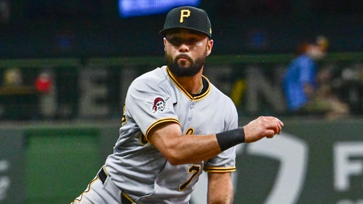 Jun 24, 2025; Milwaukee, Wisconsin, USA; Milwaukee Brewers third baseman Caleb Durbin (21) breaks up a double play attempt by Pittsburgh Pirates shortstop Isiah Kiner-Falefa in the eighth inning at American Family Field.