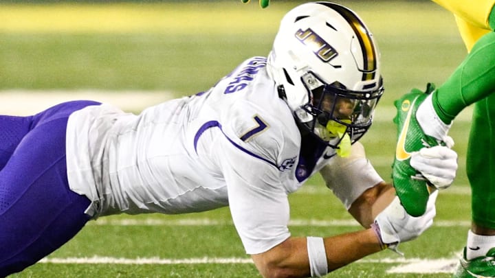 James Madison Dukes safety Jacob Thomas tries to make a tackle against Oregon. James Madison Dukes safety Jacob Thomas tries to make a tackle against Oregon.