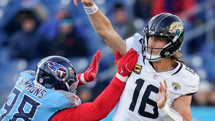 Jacksonville Jaguars quarterback Trevor Lawrence under pressure from Tennessee Titans defensive tackle Jeffery Simmons.