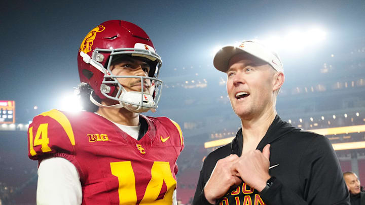 Nov 29, 2025; Los Angeles, California, USA; Southern California Trojans quarterback Jayden Maiava (14) and head coach Lincoln Riley react after the game against the UCLA Bruins at United Airlines Field at Los Angeles Memorial Coliseum. Mandatory Credit: Kirby Lee-Imagn Images