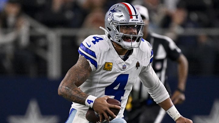 Dallas Cowboys quarterback Dak Prescott runs with the ball during the game between the Cowboys and the Arizona Cardinals.