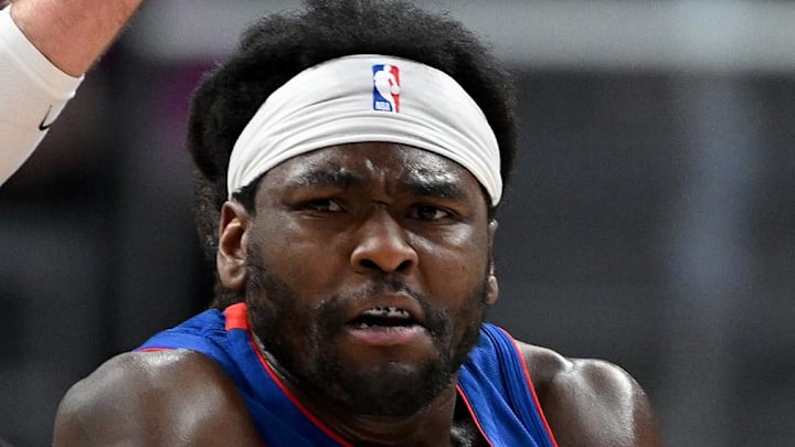 Detroit Pistons forward Isaiah Stewart (28) passes the ball to teammate Cade Cunningham (2) while being defended by Denver Nuggets center Jonas Valanciunas (17) in the fourth quarter at Little Caesars Arena on Feb 3, 2026.