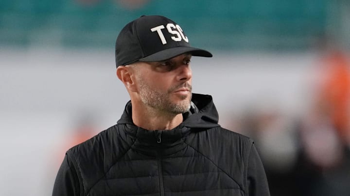 Jan 19, 2026; Miami Gardens, FL, USA; Las Vegas Raiders general manager John Spytek walks on the sideline before the CFP National Championship college football game between the Indiana Hoosiers and the Miami Hurricanes at Hard Rock Stadium. Mandatory Credit: Kirby Lee-Imagn Images