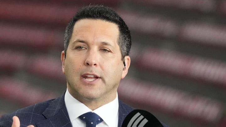 Adam Schefter talks on a set before the 2024 CFP national championship between Michigan and Washington.