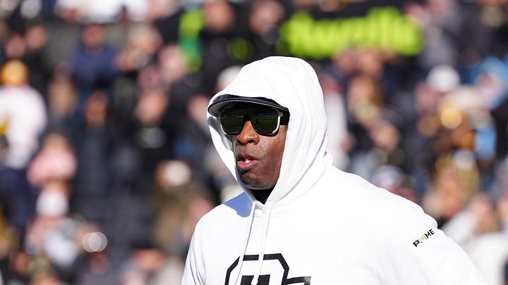 Nov 29, 2024; Boulder, Colorado, USA; Colorado Buffaloes head coach Deion Sanders runs onto the field before the game against the Oklahoma State Cowboys at Folsom Field. Mandatory Credit: Ron Chenoy-Imagn Images
