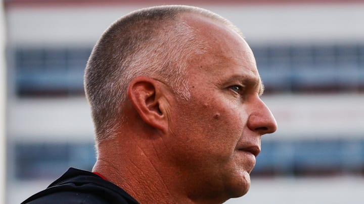 Aug 28, 2025; Raleigh, North Carolina, USA; North Carolina State Wolfpack head coach Dave Doeren looks on during the warmups prior to the game against East Carolina Pirates at Carter-Finley Stadium. Mandatory Credit: Jaylynn Nash-Imagn Images