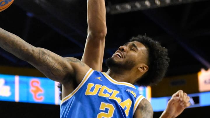 Feb 24, 2026; Los Angeles, California, USA; UCLA Bruins guard Donovan Dent (2) scores past Southern California Trojans forwards Jacob Cofie (6) and Ezra Ausar (2) during the second half tat Pauley Pavilion presented by Wescom Financial. Mandatory Credit: Robert Hanashiro-Imagn Images Feb 24, 2026; Los Angeles, California, USA; UCLA Bruins guard Donovan Dent (2) scores past Southern California Trojans forwards Jacob Cofie (6) and Ezra Ausar (2) during the second half tat Pauley Pavilion presented by Wescom Financial. Mandatory Credit: Robert Hanashiro-Imagn Images