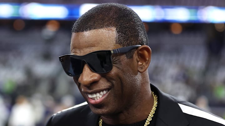 Nov 30, 2023; Arlington, Texas, USA; Colorado Buffaloes head coach Deion Sanders (right) talks with Dallas Cowboys owner Jerry Jones before the game against the Seattle Seahawks at AT&T Stadium. Mandatory Credit: Tim Heitman-Imagn Images