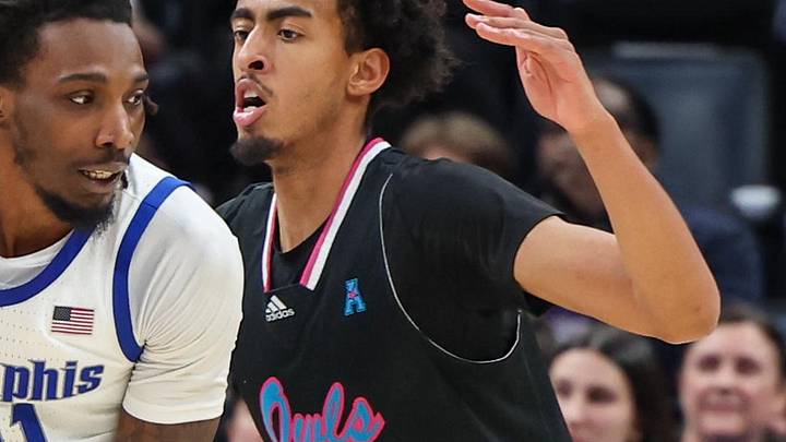 Jan 29, 2026; Memphis, Tennessee, USA; Memphis Tigers forward Aaron Bradshaw (11) drives against Florida Atlantic Owls forward Devin Williams (1) during the second half at FedExForum. Mandatory Credit: Wesley Hale-Imagn Images