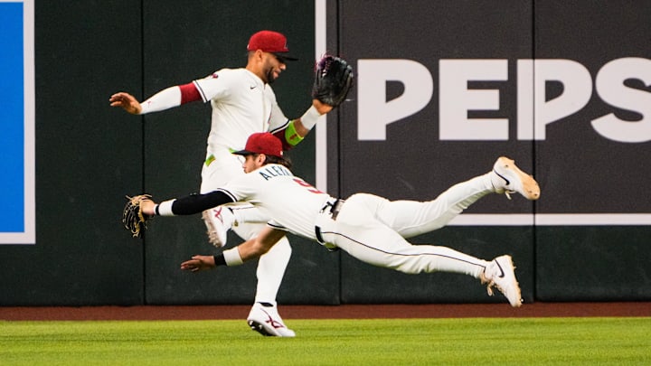 Sep 1, 2025; Phoenix, Arizona, USA; Arizona Diamondbacks centerfielder Blaze Alexander (9) and Arizona Diamondbacks outfielder Lourdes Gurriel Jr. (12) collide in the outfield. Gurriel Jr. was taken off by cart in the sixth inning during the game between the Texas Rangers and Arizona Diamondbacks at Chase Field. Mandatory Credit: Arianna Grainey-Imagn Images Sep 1, 2025; Phoenix, Arizona, USA; Arizona Diamondbacks centerfielder Blaze Alexander (9) and Arizona Diamondbacks outfielder Lourdes Gurriel Jr. (12) collide in the outfield. Gurriel Jr. was taken off by cart in the sixth inning during the game between the Texas Rangers and Arizona Diamondbacks at Chase Field. Mandatory Credit: Arianna Grainey-Imagn Images
