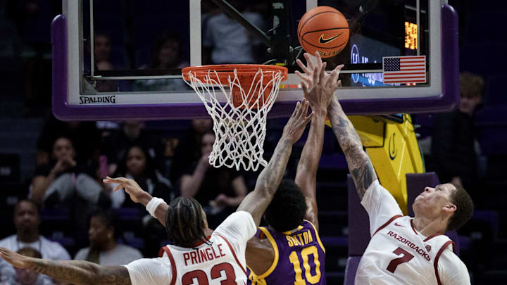 LSU Tigers forward Marquel Sutton (10) shoots against Arkansas Razorbacks forward Trevon Brazile (7) and forward Nick Pringle (23) at the Pete Maravich Assembly Center in Baton Rouge, La.