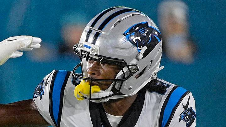 Carolina Panthers wide receiver John Metchie III stiff-arms Jacksonville Jaguars linebacker Jahlani Tavai.