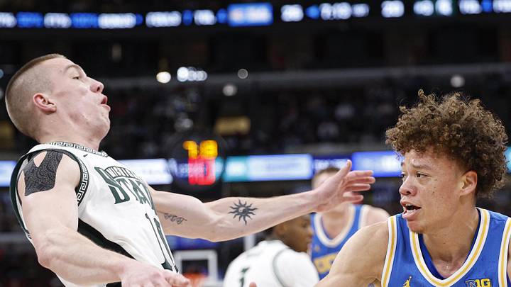 Mar 13, 2026; Chicago, IL, USA; UCLA Bruins guard Trent Perry (0) fouls Michigan State Spartans guard Denham Wojcik (10) during the first half at United Center. Mandatory Credit: Kamil Krzaczynski-Imagn Images