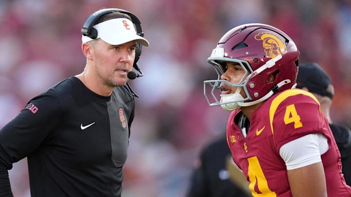 Aug 30, 2025; Los Angeles, California, USA; Southern California Trojans head coach Lincoln Riley talks with Southern California Trojans quarterback Husan Longstreet (4) in the second half against the Missouri State Bears at United Airlines Field at Los Angeles Memorial Coliseum. Mandatory Credit: Kirby Lee-Imagn Images