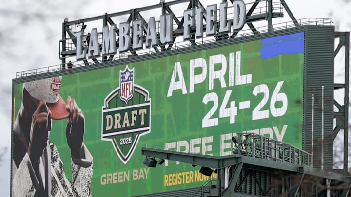 A Lambeau Field jumbotron, seen from a neighborhood in Ashwaubenon, Wis. April 21, 2025, advertises the 2025 NFL Draft.