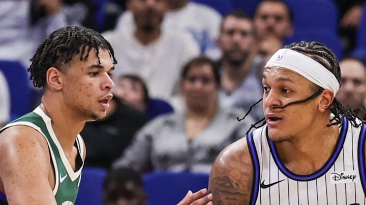 Milwaukee Bucks forward Ousmane Dieng defends Orlando Magic forward Paolo Banchero.