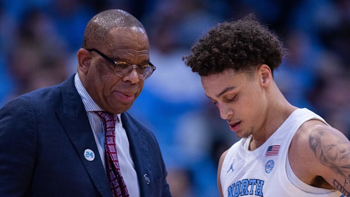 Dec 22, 2025; Chapel Hill, North Carolina, USA; North Carolina Tar Heels head coach Hubert Davis talks with guard Kyan Evans (0) during the first half against the East Carolina Pirates at Dean E. Smith Center. Mandatory Credit: Scott Kinser-Imagn Images Dec 22, 2025; Chapel Hill, North Carolina, USA; North Carolina Tar Heels head coach Hubert Davis talks with guard Kyan Evans (0) during the first half against the East Carolina Pirates at Dean E. Smith Center. Mandatory Credit: Scott Kinser-Imagn Images