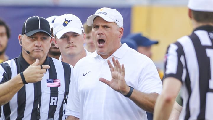 Sep 13, 2025; Morgantown, West Virginia, USA; West Virginia Mountaineers head coach Rich Rodriguez yells at the referee during the second quarter against the Pittsburgh Panthers at Milan Puskar Stadium. Mandatory Credit: Ben Queen-Imagn Images