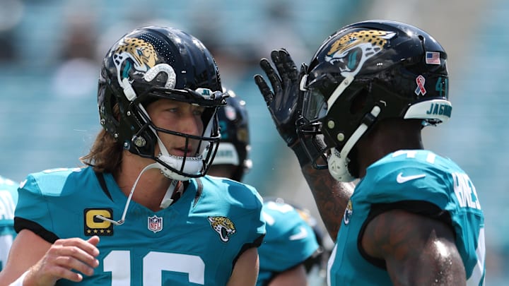 Sep 7, 2025; Jacksonville, Florida, USA; Jacksonville Jaguars quarterback Trevor Lawrence (16) and defensive end Josh Hines-Allen (41) talk prior to a game against the Carolina Panthers at EverBank Stadium. Mandatory Credit: Nathan Ray Seebeck-Imagn Images