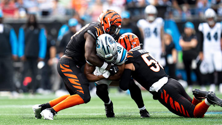 Cincinnati Bengals linebacker Germaine Pratt (57) and Cincinnati Bengals linebacker Logan Wilson (55) tackle Carolina Panthers running back Chuba Hubbard (30) in the fourth quarter of the NFL game at Bank of America Stadium in Charlotte, N.C., on Sunday, Sept. 29, 2024.