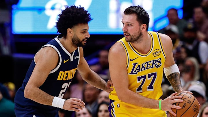 Mar 5, 2026; Denver, Colorado, USA; Los Angeles Lakers guard Luka Doncic (77) controls the ball against Denver Nuggets guard Jamal Murray (27) as guard Christian Braun (0) defends in the first quarter at Ball Arena. Mar 5, 2026; Denver, Colorado, USA; Los Angeles Lakers guard Luka Doncic (77) controls the ball against Denver Nuggets guard Jamal Murray (27) as guard Christian Braun (0) defends in the first quarter at Ball Arena.
