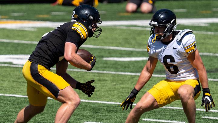 Iowa defensive backs Deshaun Lee (8) and Zach Lutmer (6) defend wide receiver Reece Vander Zee (2) as he runs for extra yards after a catch April 25, 2026 during the team’s spring practice at Kinnick Stadium in Iowa City, Iowa.