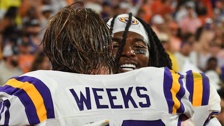 LSU Tigers linebacker Whit Weeks (40) hugs LSU Tigers linebacker Harold Perkins Jr. (7) Saturday, Aug. 30, 2025 after the NCAA football game between the Clemson Tigers and the LSU Tigers at Memorial Stadium in Clemson, South Carolina.