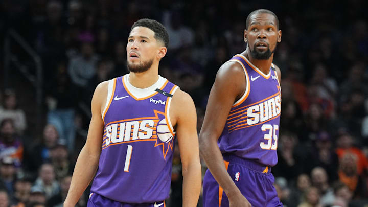 Nov 27, 2024; Phoenix, Arizona, USA; Phoenix Suns guard Devin Booker (1) and Phoenix Suns forward Kevin Durant (35) look on against the Brooklyn Nets during the first half at Footprint Center. Mandatory Credit: Joe Camporeale-Imagn Images