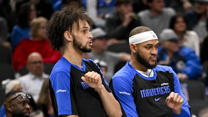 Dec 23, 2024; Dallas, Texas, USA; Dallas Mavericks center Dereck Lively II (left) and center Daniel Gafford (center) and guard Quentin Grimes (right) celebrate on the team bench during the second half against the Portland Trail Blazers at the American Airlines Center. Mandatory Credit: Jerome Miron-Imagn Images