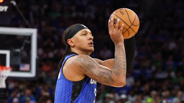 Apr 27, 2025; Orlando, Florida, USA; Orlando Magic forward Paolo Banchero (5) shoots a three point shot against the Boston Celtics in the first quarter during game four of first round for the 2025 NBA Playoffs at Kia Center. Mandatory Credit: Nathan Ray Seebeck-Imagn Images