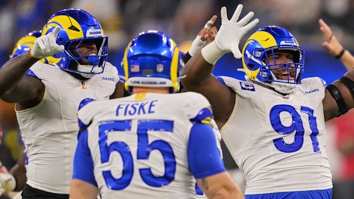 Nov 23, 2025; Inglewood, California, USA; Los Angeles Rams defensive end Kobie Turner (91) celebrates with linebacker Jared Verse (8) and defensive end Braden Fiske (55) after sacking quarterback Baker Mayfield (not pictured) during the second quarter at SoFi Stadium. Mandatory Credit: Jayne Kamin-Oncea-Imagn Images Nov 23, 2025; Inglewood, California, USA; Los Angeles Rams defensive end Kobie Turner (91) celebrates with linebacker Jared Verse (8) and defensive end Braden Fiske (55) after sacking quarterback Baker Mayfield (not pictured) during the second quarter at SoFi Stadium. Mandatory Credit: Jayne Kamin-Oncea-Imagn Images