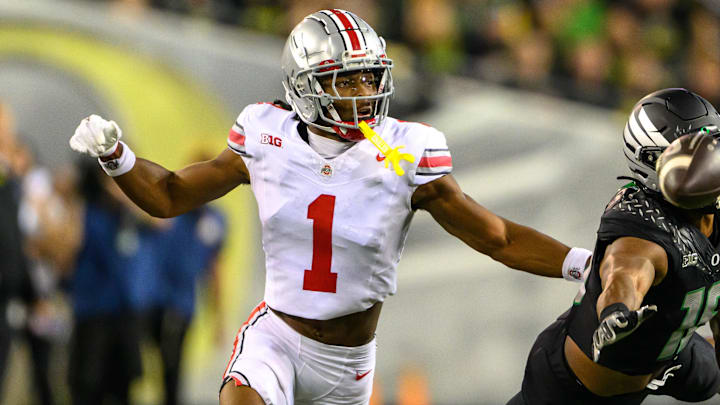 Oct 12, 2024; Eugene, Oregon, USA; Oregon Ducks tight end Kenyon Sadiq (18) dives for the ball with Ohio State Buckeyes cornerback Davison Igbinosun (1) in coverage during the third quarter at Autzen Stadium. Mandatory Credit: Craig Strobeck-Imagn Images Oct 12, 2024; Eugene, Oregon, USA; Oregon Ducks tight end Kenyon Sadiq (18) dives for the ball with Ohio State Buckeyes cornerback Davison Igbinosun (1) in coverage during the third quarter at Autzen Stadium. Mandatory Credit: Craig Strobeck-Imagn Images
