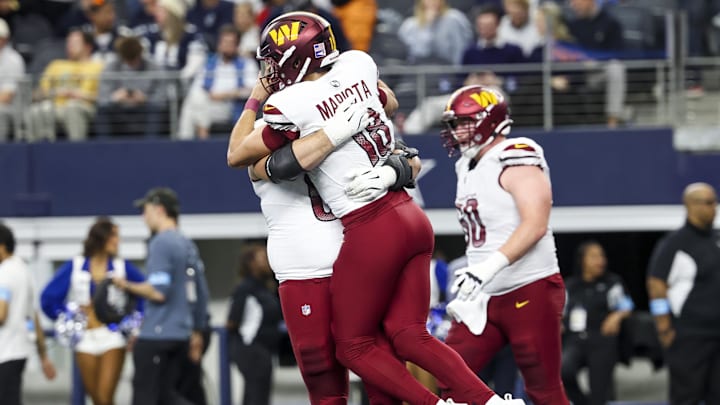 Jan 5, 2025; Arlington, Texas, USA;  Washington Commanders quarterback Marcus Mariota (18) celebrates with teammates during the fourth quarter against the Dallas Cowboys at AT&T Stadium. Mandatory Credit: Kevin Jairaj-Imagn Images
