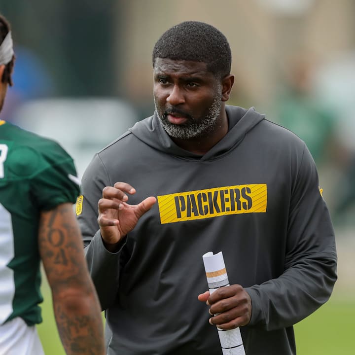 Green Bay Packers defensive passing game coordinator Derrick Ansley gives instruction to cornerback Jaire Alexander 