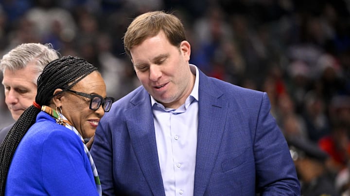 Dec 25, 2024; Dallas, Texas, USA; Dallas Mavericks governor Patrick Dumont presents retiring Mavericks CEO Cynt Marshall with a jersey during the game between the Dallas Mavericks and the Minnesota Timberwolves at the American Airlines Center. Mandatory Credit: Jerome Miron-Imagn Images