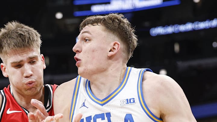 Mar 12, 2026; Chicago, IL, USA; UCLA Bruins forward Tyler Bilodeau (34) drives to the basket against Rutgers Scarlet Knights guard Harun Zrno (13) during the second half at United Center. Mandatory Credit: Kamil Krzaczynski-Imagn Images