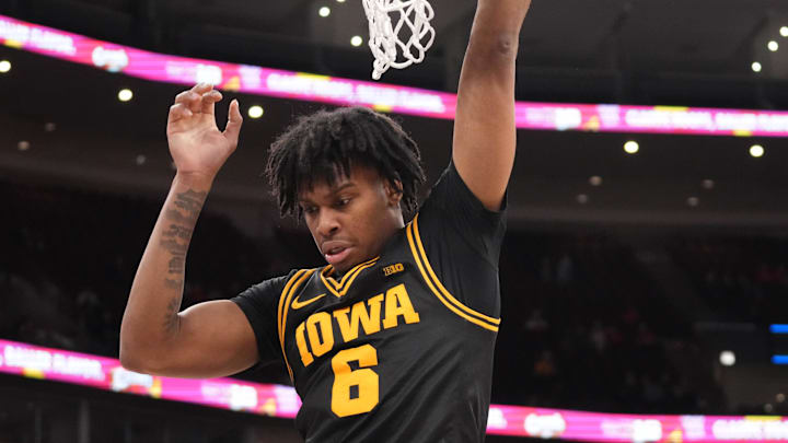 Mar 12, 2026; Chicago, IL, USA; Iowa Hawkeyes guard Tavion Banks (6) dunks the ball on Ohio State Buckeyes center Christoph Tilly (13) during the second half at United Center. Mandatory Credit: David Banks-Imagn Images