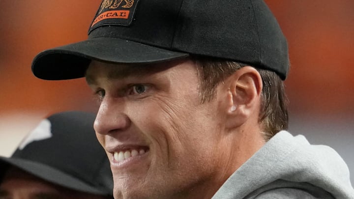 Jan 19, 2026; Miami Gardens, FL, USA; Tom Brady looks on from the sideline before the CFP National Championship college football game between the Indiana Hoosiers and the Miami Hurricanes at Hard Rock Stadium. Mandatory Credit: Kirby Lee-Imagn Images