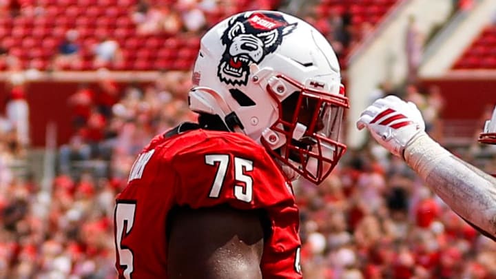 Sep 6, 2025; Raleigh, North Carolina, USA; North Carolina State Wolfpack running back Hollywood Smothers (3), guard Anthony Carter Jr. (75), and quarterback CJ Bailey (11) celebrate a touchdown during the second half of the game against Virginia Cavaliers at Carter-Finley Stadium. Mandatory Credit: Jaylynn Nash-Imagn Images