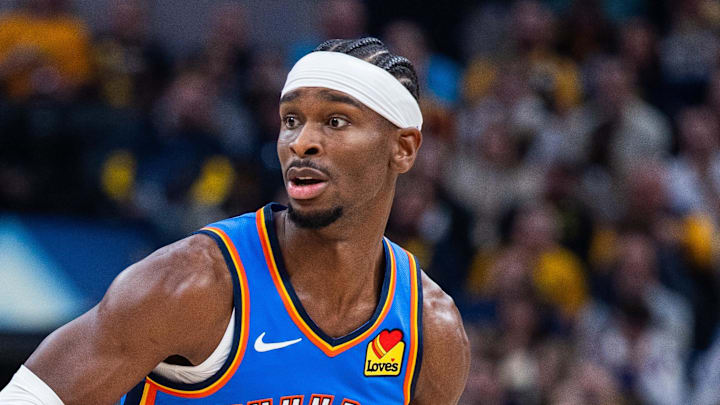 Oct 23, 2025; Indianapolis, Indiana, USA; Oklahoma City Thunder guard Shai Gilgeous-Alexander (2) dribbles the ball while Indiana Pacers guard Bennedict Mathurin (00) defends in the first half at Gainbridge Fieldhouse. Mandatory Credit: Trevor Ruszkowski-Imagn Images