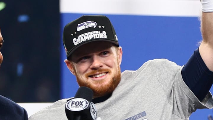 Jan 25, 2026; Seattle, WA, USA; Seattle Seahawks quarterback Sam Darnold (14) celebrates on the podium after defeating the Los Angeles Rams in the 2026 NFC Championship Game at Lumen Field. Mandatory Credit: Kevin Ng-Imagn Images