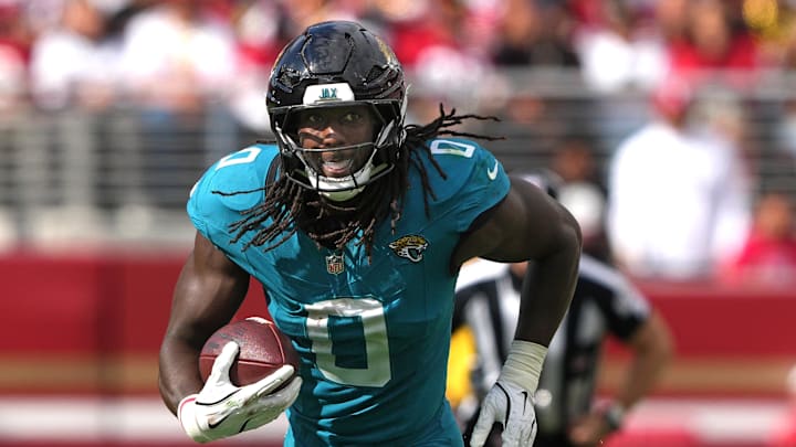 Sep 28, 2025; Santa Clara, California, USA; Jacksonville Jaguars linebacker Devin Lloyd (0) returns an interception against the San Francisco 49ers during the third quarter at Levi's Stadium. Mandatory Credit: Darren Yamashita-Imagn Images