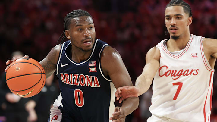 Feb 21, 2026; Houston, Texas, USA;  Arizona Wildcats guard Jaden Bradley (0) dribbles against Houston Cougars guard Milos Uzan (7) in the first half at Fertitta Center. Mandatory Credit: Thomas Shea-Imagn Images