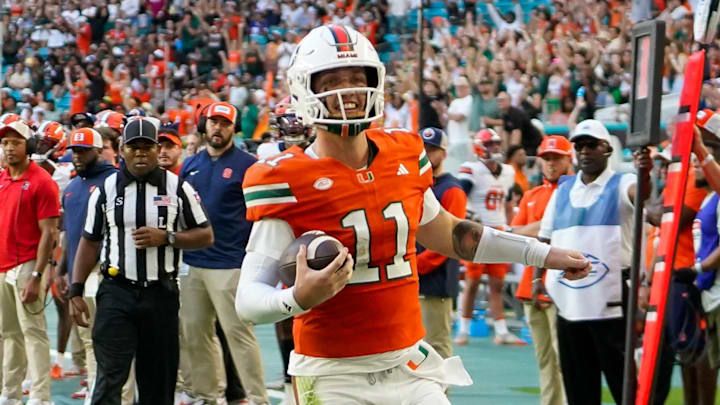 Nov 8, 2025; Miami Gardens, Florida, USA; Miami Hurricanes quarterback Carson Beck (11) catches a touchdown pass against the Syracuse Orange during the second quarter at Hard Rock Stadium. Mandatory Credit: Jeff Romance-Imagn Images Nov 8, 2025; Miami Gardens, Florida, USA; Miami Hurricanes quarterback Carson Beck (11) catches a touchdown pass against the Syracuse Orange during the second quarter at Hard Rock Stadium. Mandatory Credit: Jeff Romance-Imagn Images